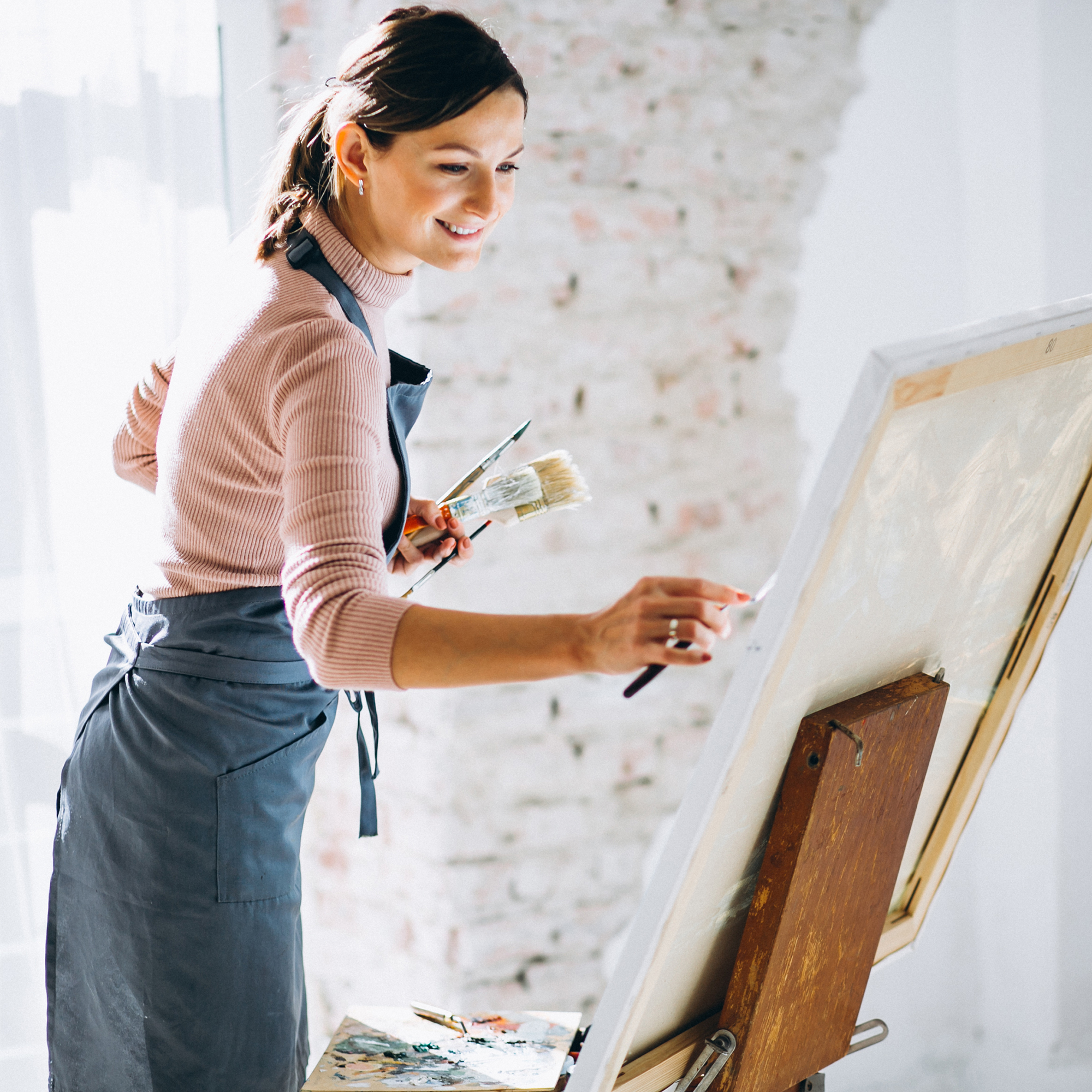 Female artist painting in studio